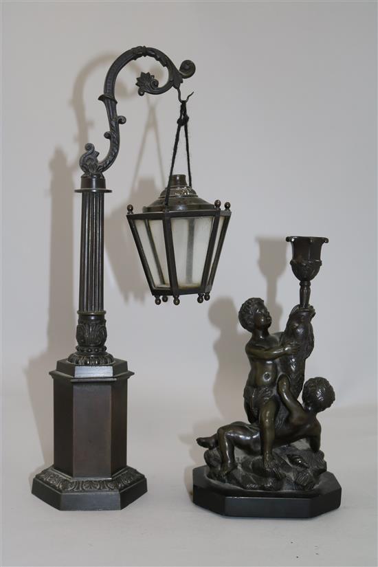 A bronze candlestick & a miniature lantern